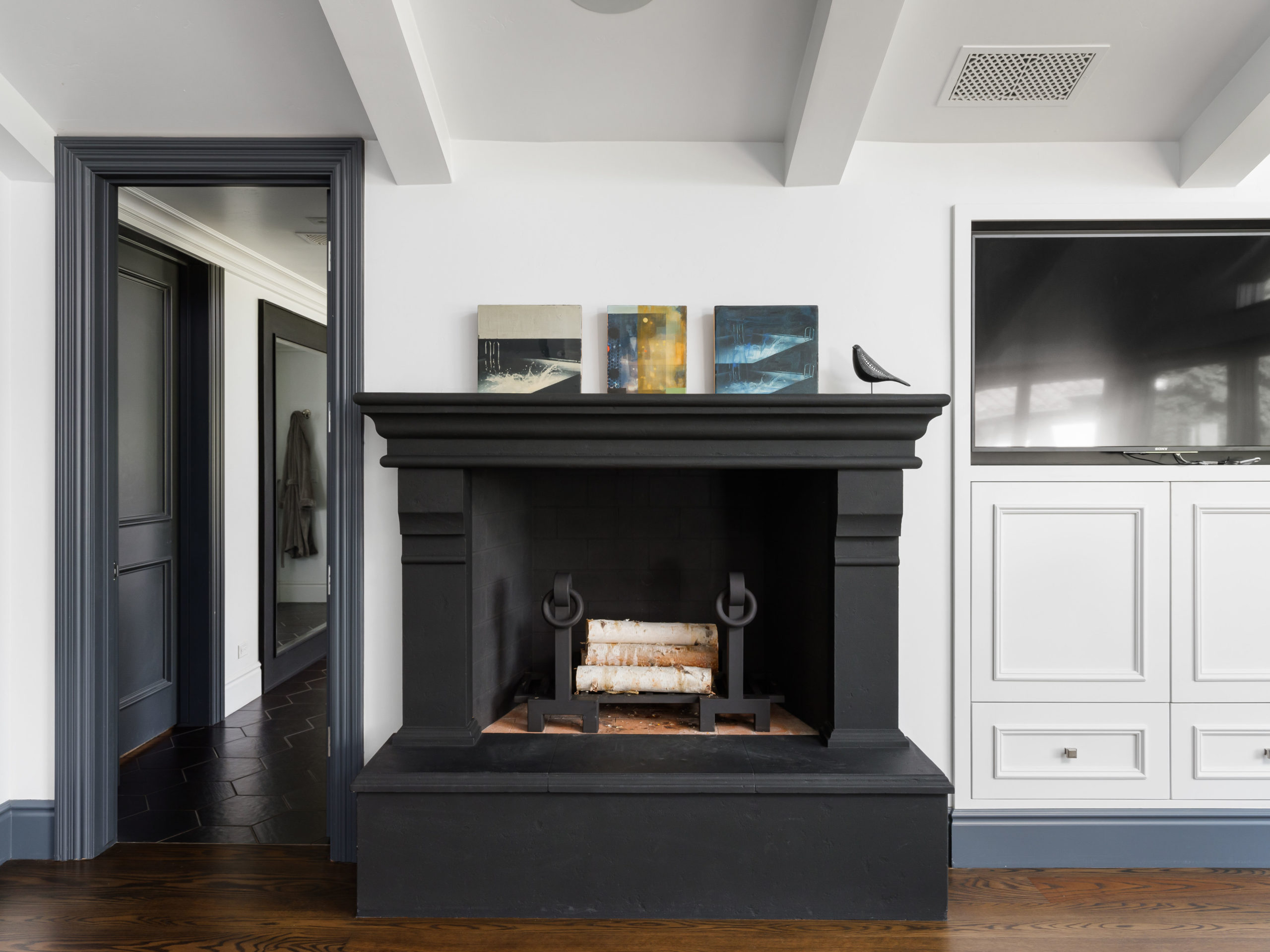 dark fireplace against a white wall