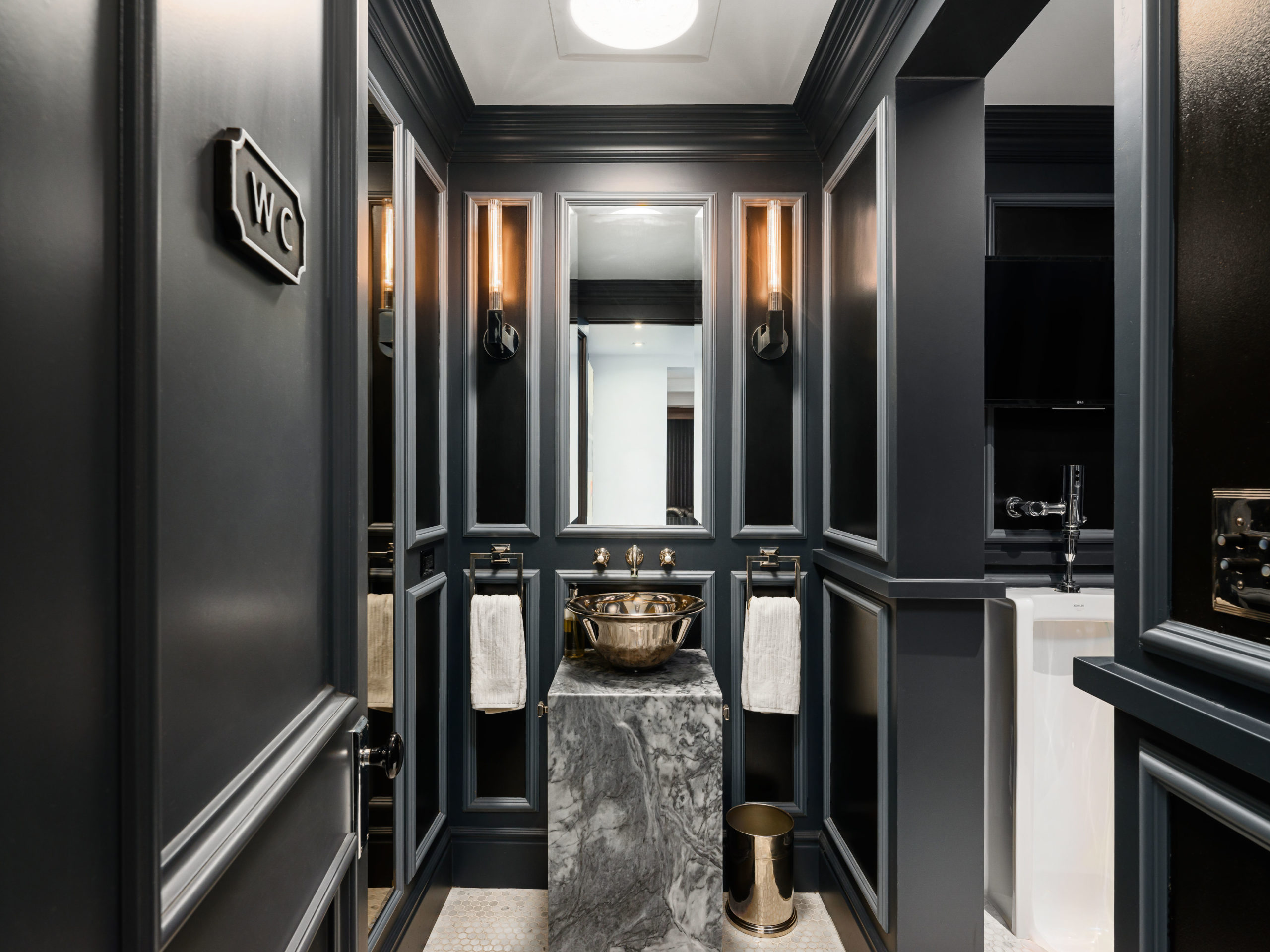 dramatic powder room with mirror and vessel sink