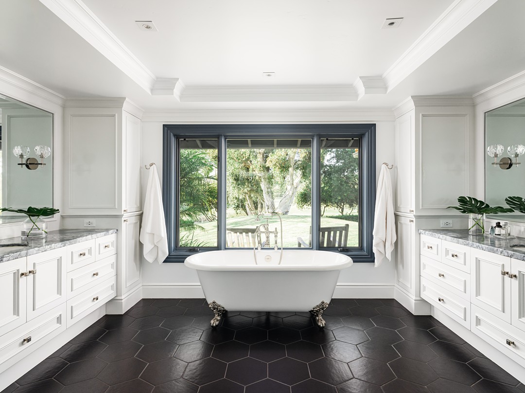 clawfoot bathtub in master bathroom with large picture window