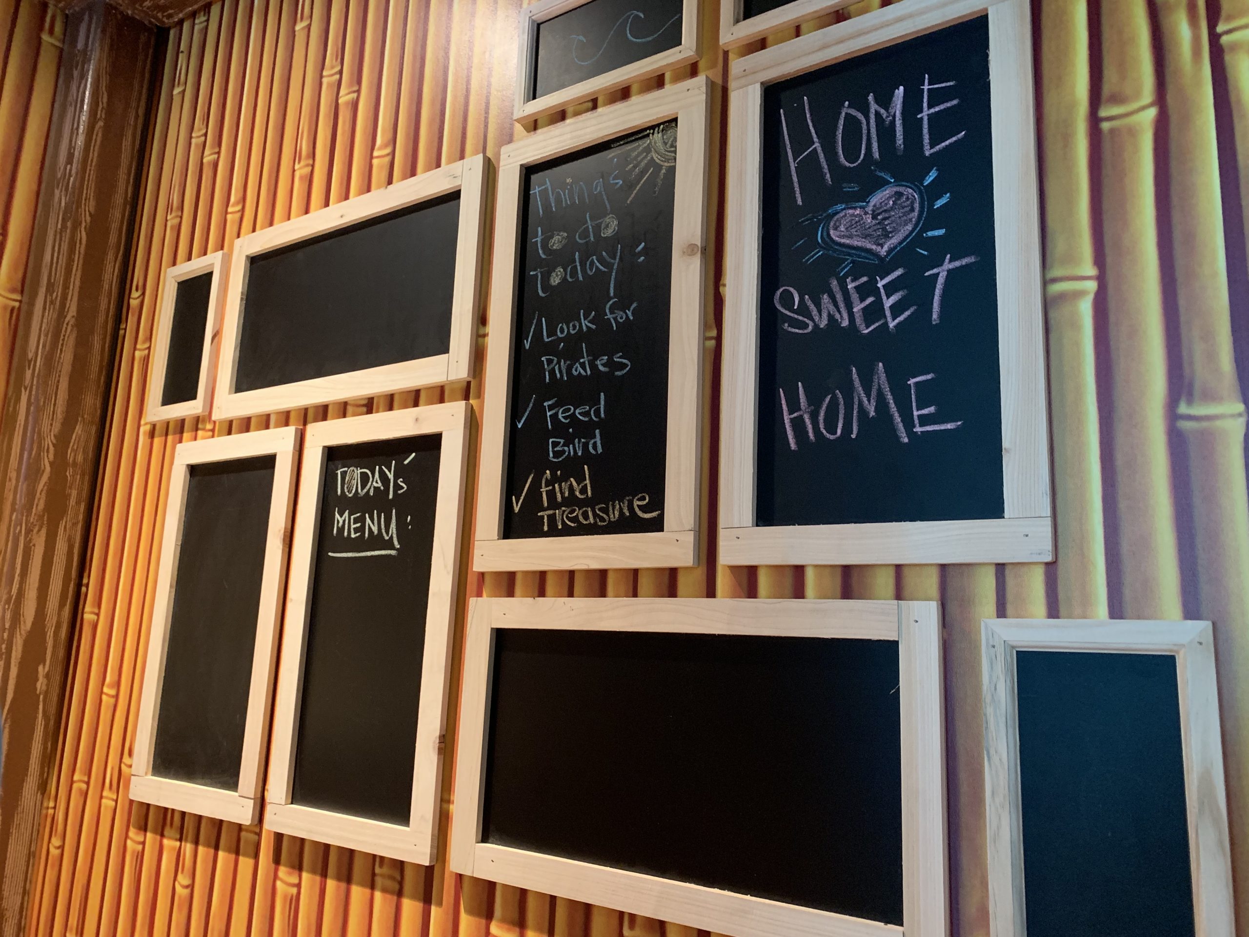 Chalk boards hanging on bamboo wall