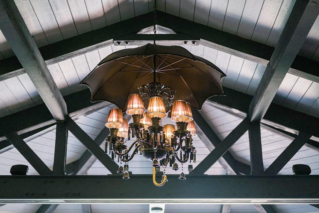 vaulted ceilings with beams and chandelier