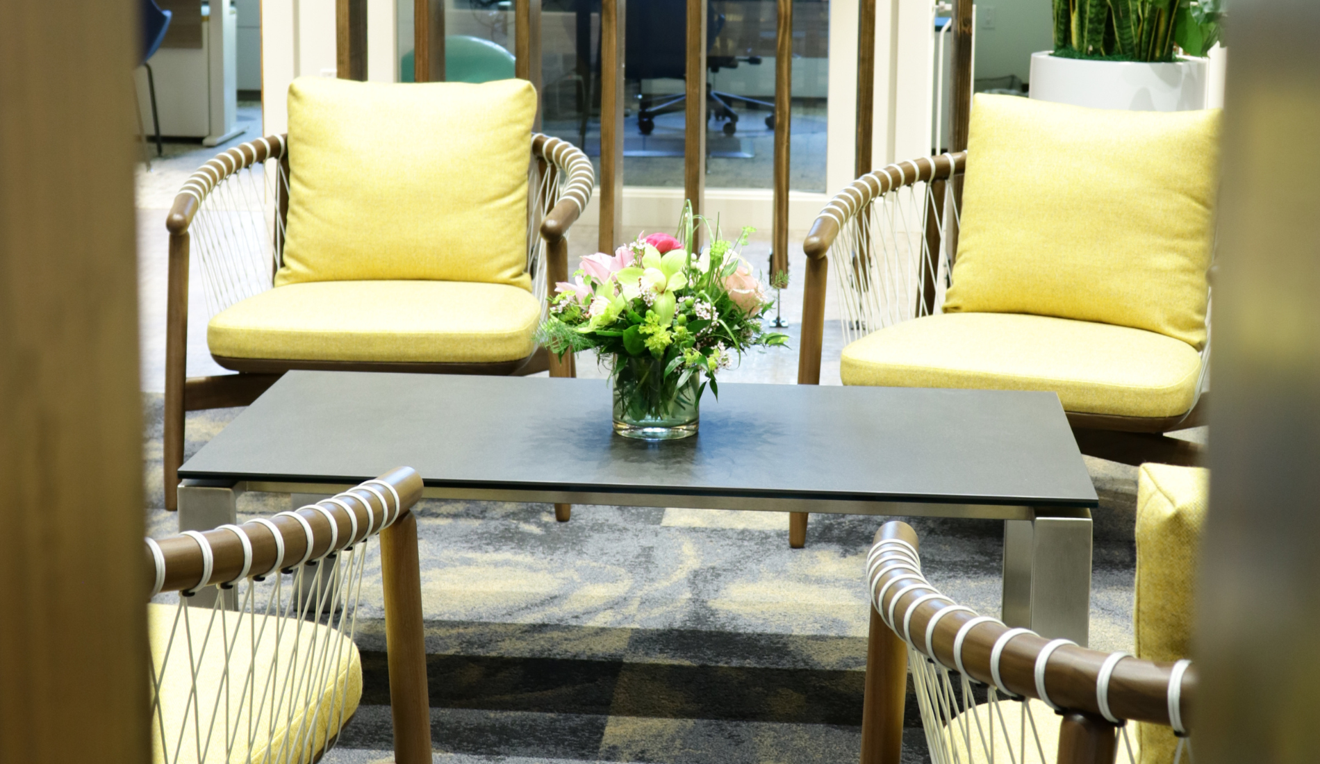San Diego Interior Design seating area in office with yellow chairs, table, and rug