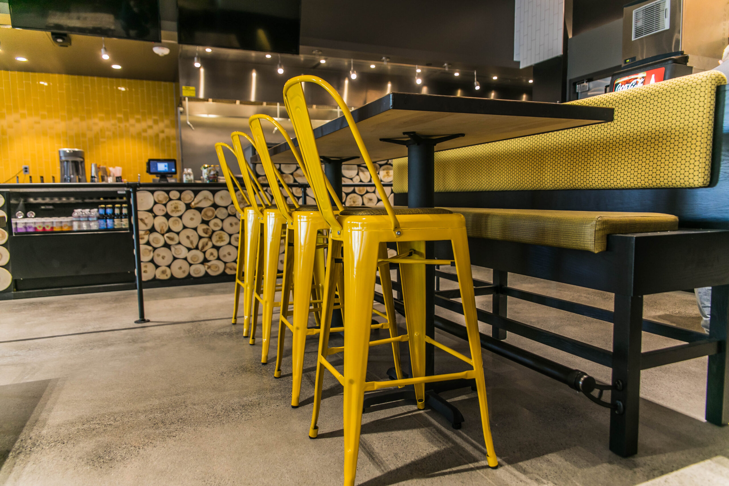Fast Casual Burger restaurant, bar and dining area with yellow stools, seating and tables
