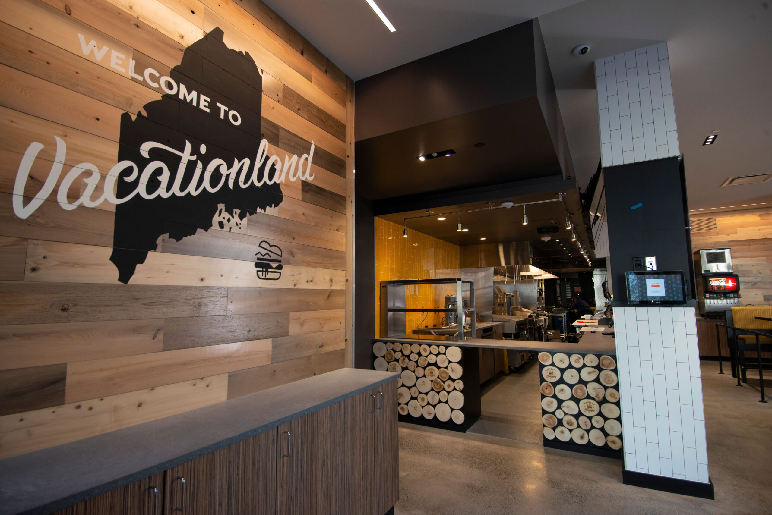Fast Causal Burger Restaurant Interior Design with wood wall featuring state image and logo