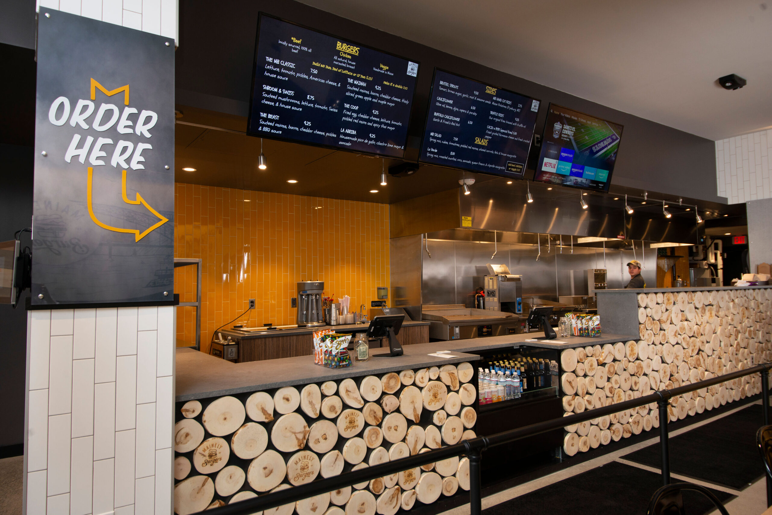 Fast Casual Burger restaurant interior design with wood wall decor, menu, cashier