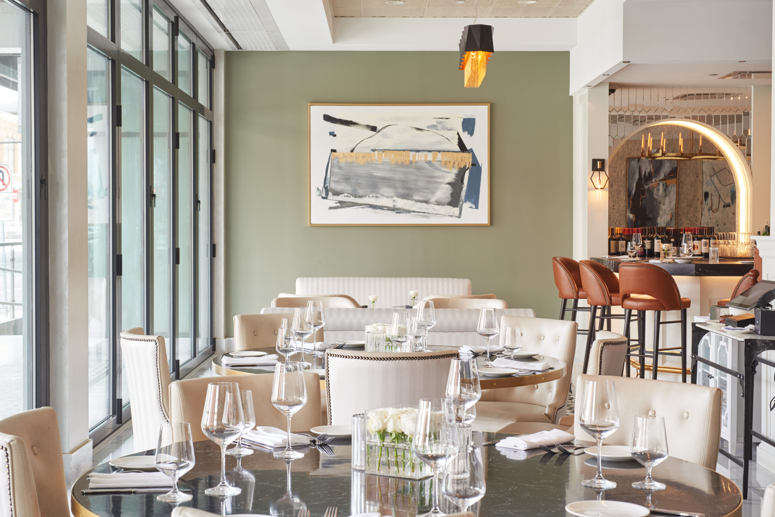 Elegant restaurant lounge and steakhouse interior design, white seating in front of green wall