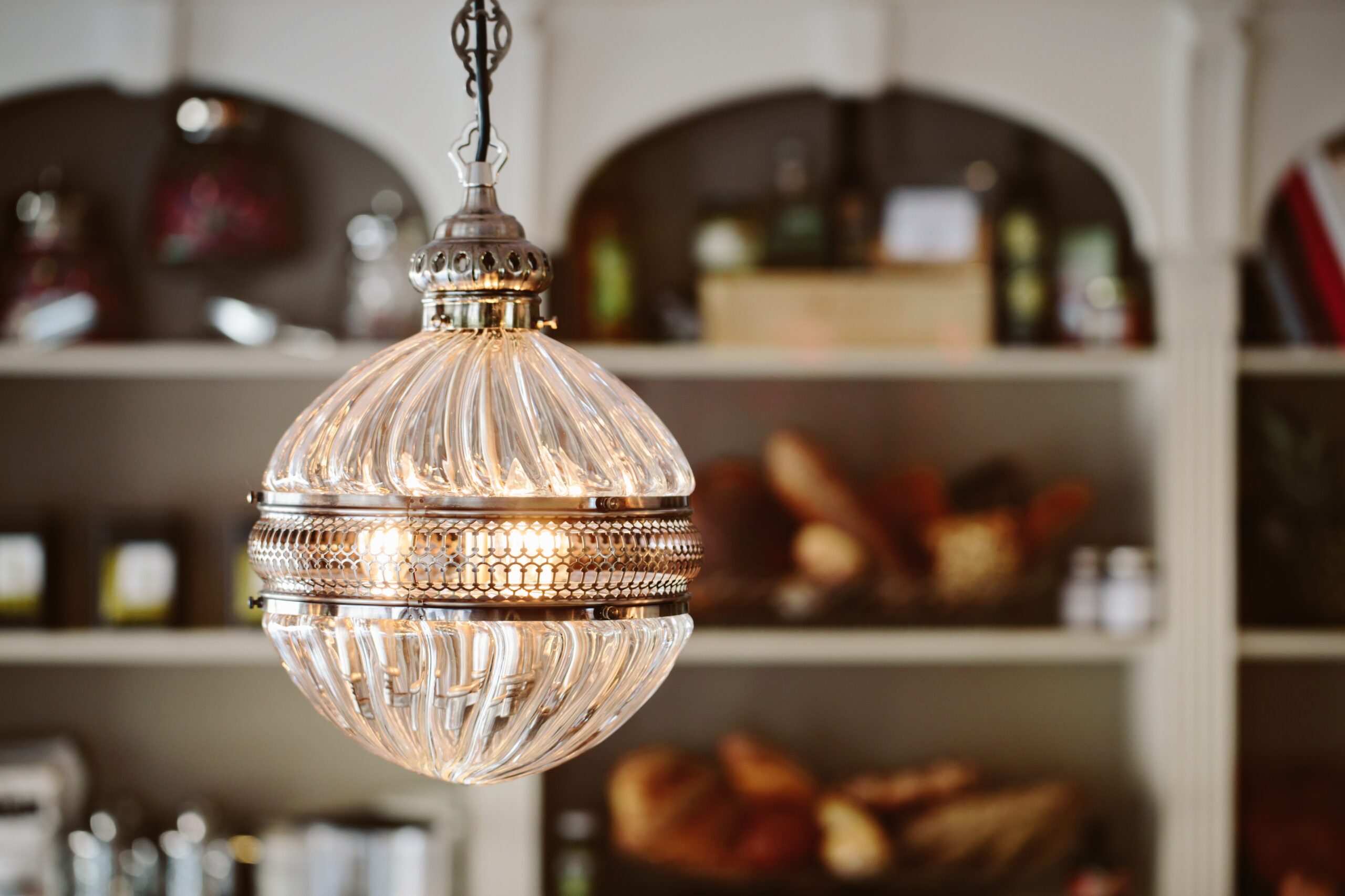 Restaurant Interior Design and Lighting, chandelier and shelving with food and small objects